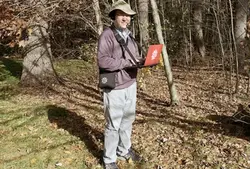 Wolfram walking in the woods while working on his laptop